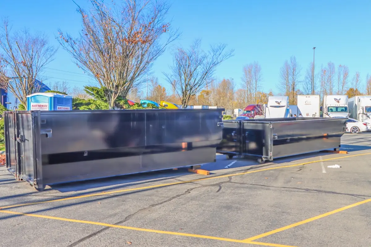 Professional dumpster rental service with roll-off container on residential driveway in Hailey